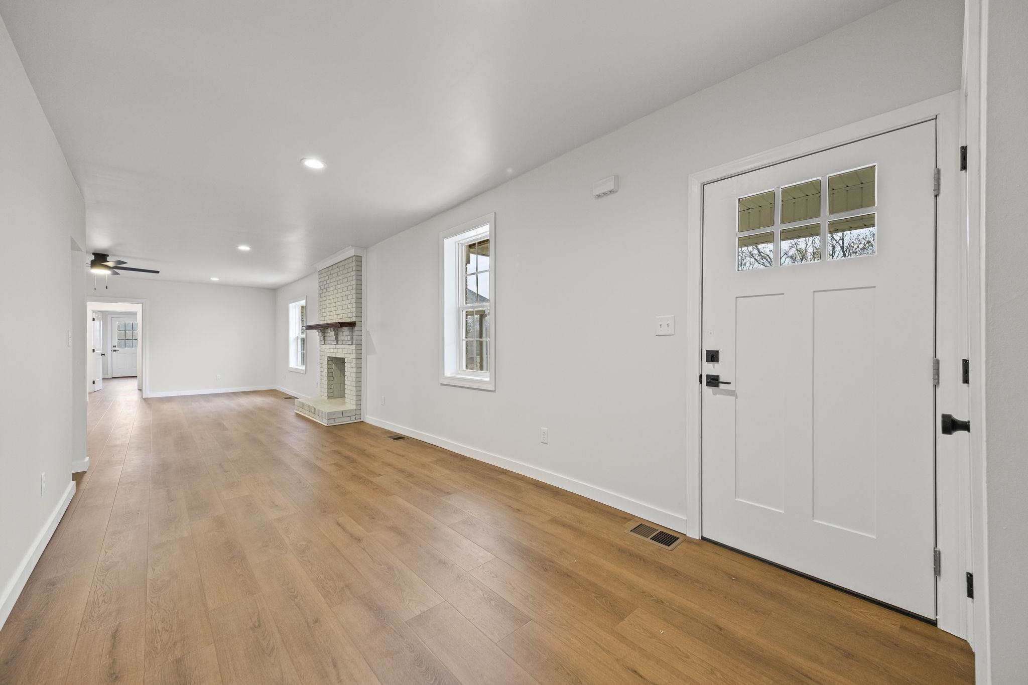 835 Curve Woodville Road Gates, TN 38037 - Photo 3 of 33 a view of empty room with wooden floor and windows