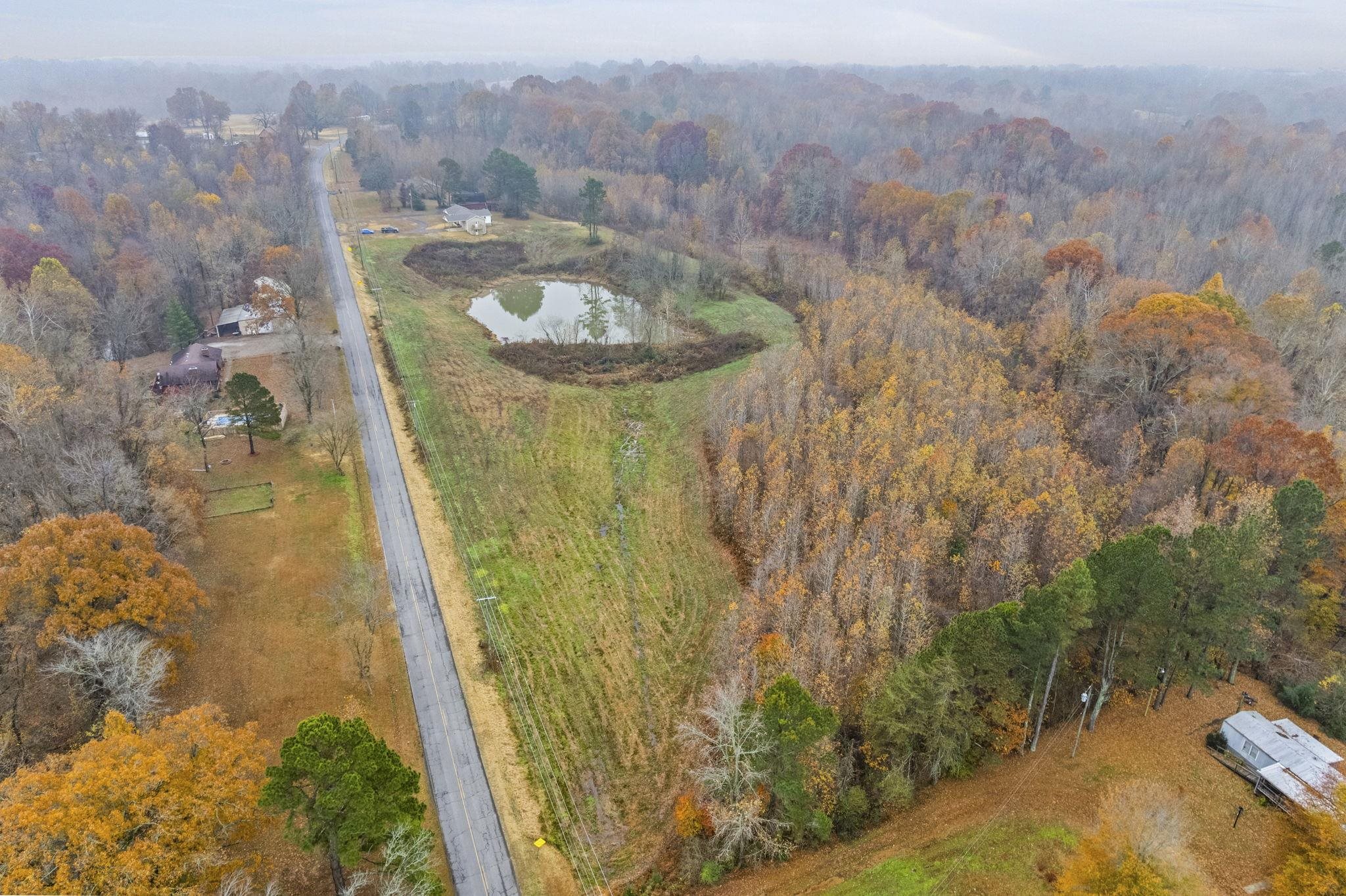 835 Curve Woodville Road Gates, TN 38037 - Photo 31 of 33 an aerial view of residential houses with outdoor space and trees
