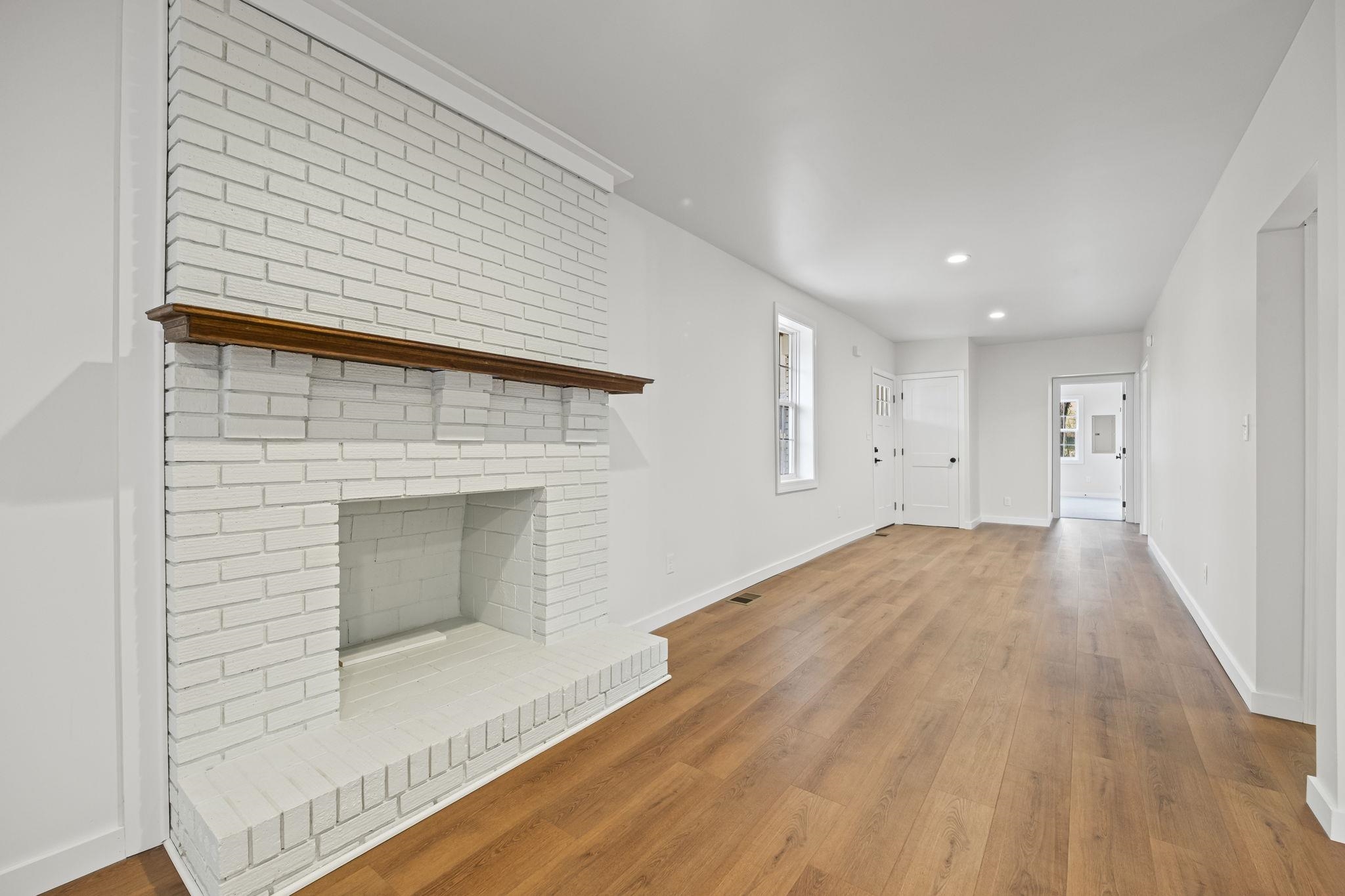 835 Curve Woodville Road Gates, TN 38037 - Photo 4 of 33 a view of empty room with wooden floor and fireplace