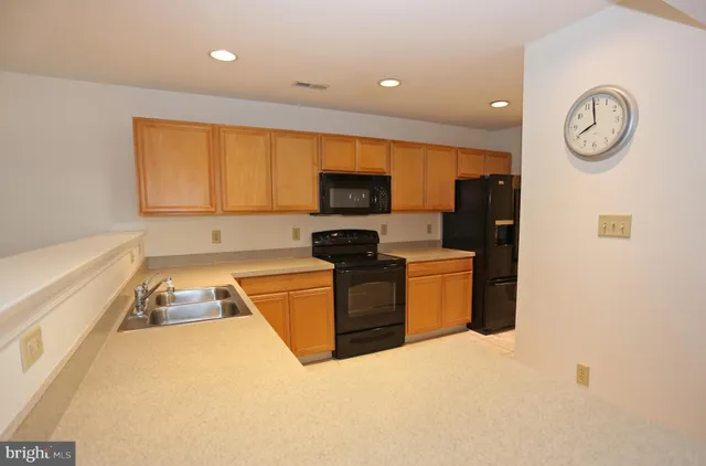 a kitchen with stainless steel appliances a refrigerator a stove a microwave and cabinets