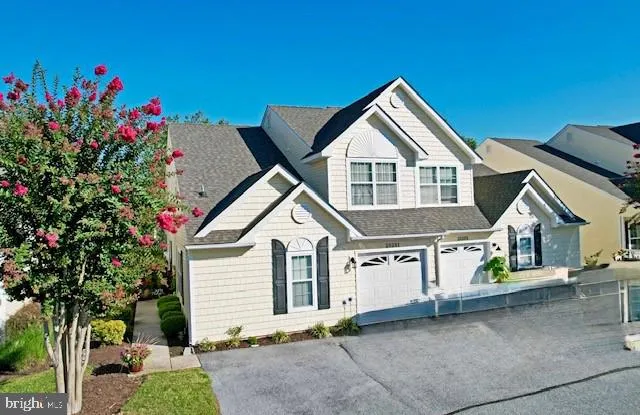 a view of a house with a yard and potted plants