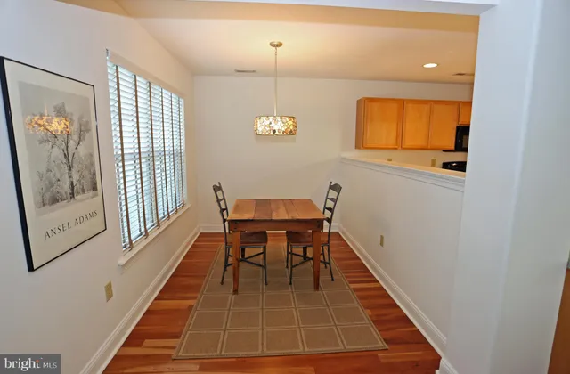 a bedroom with a bed dresser and a window