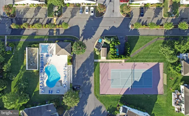 a view of house with backyard outdoor seating and hardwood floor