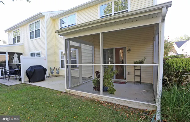 a view of a house with backyard and porch