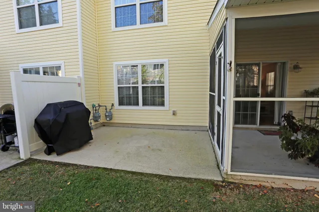 a front view of a house with a yard and potted plants