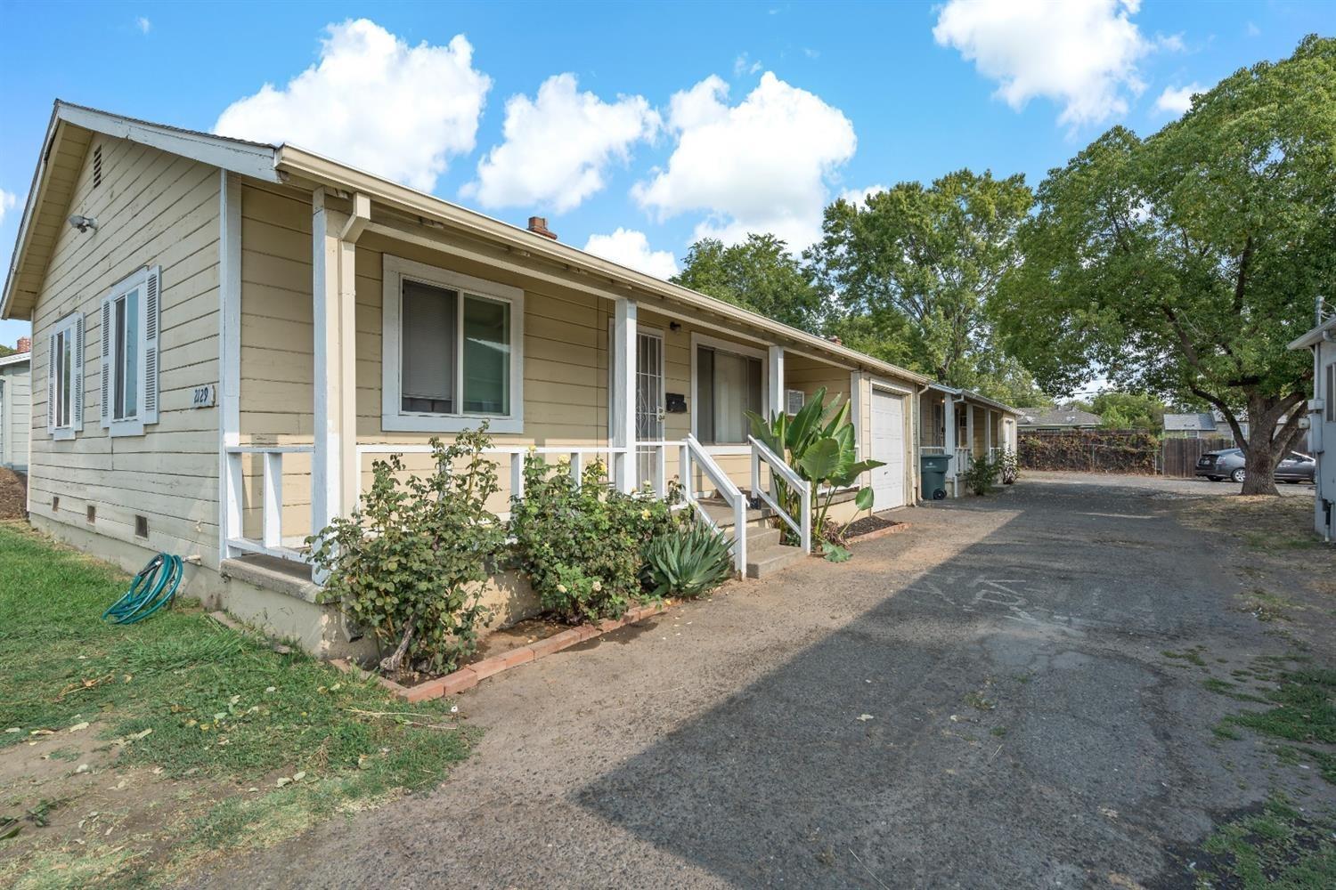 2129 Marconi Avenue Sacramento, CA 95821 - Photo 1 of 3 a front view of a house with garden