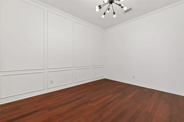 an empty room with ceiling fan and window