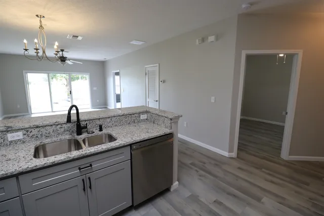 a kitchen with kitchen island sink refrigerator and microwave