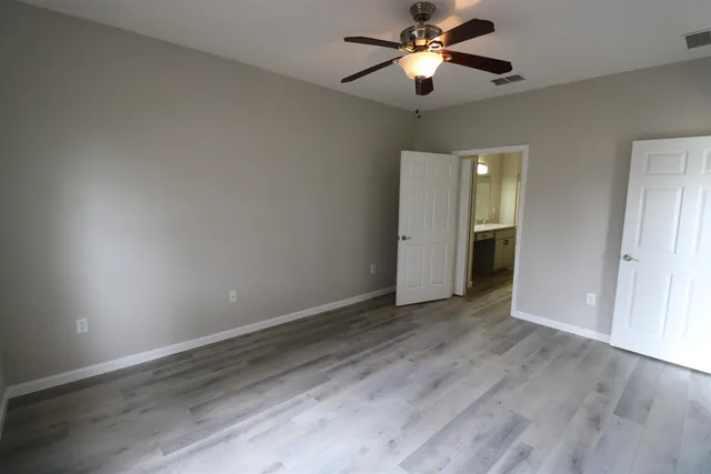 a bathroom with a granite countertop sink a mirror and a bathtub