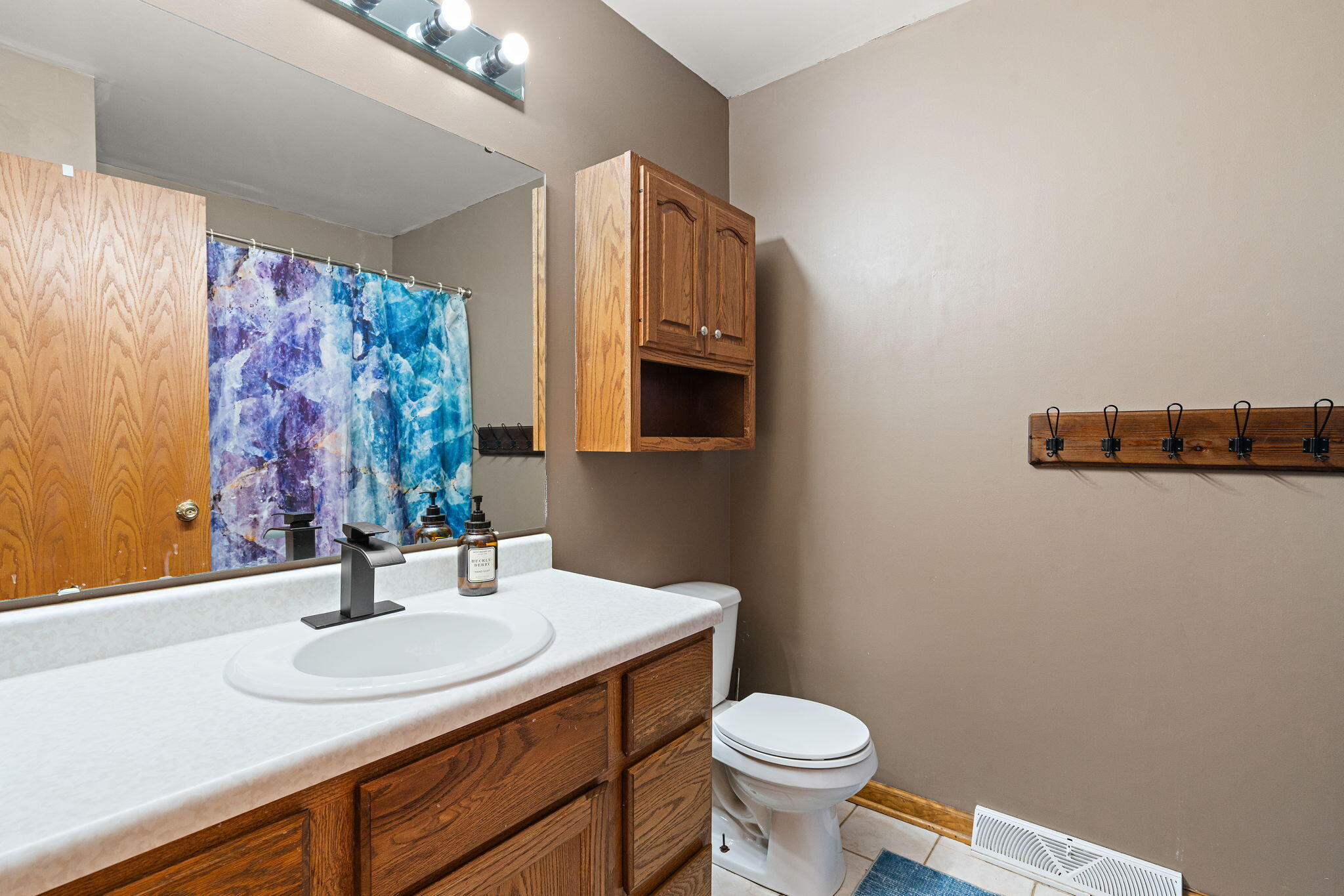 8987 Calhoun Place Crown Point, IN 46307 - Photo 17 of 28 a bathroom with a sink and a mirror