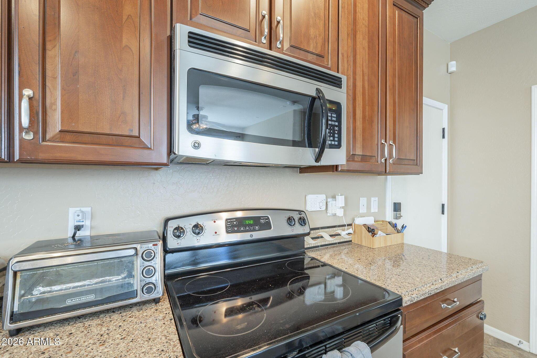 451 South Hawes Road, Unit 45 Mesa, AZ 85208 - Photo 11 of 36 a kitchen with a stove and a microwave
