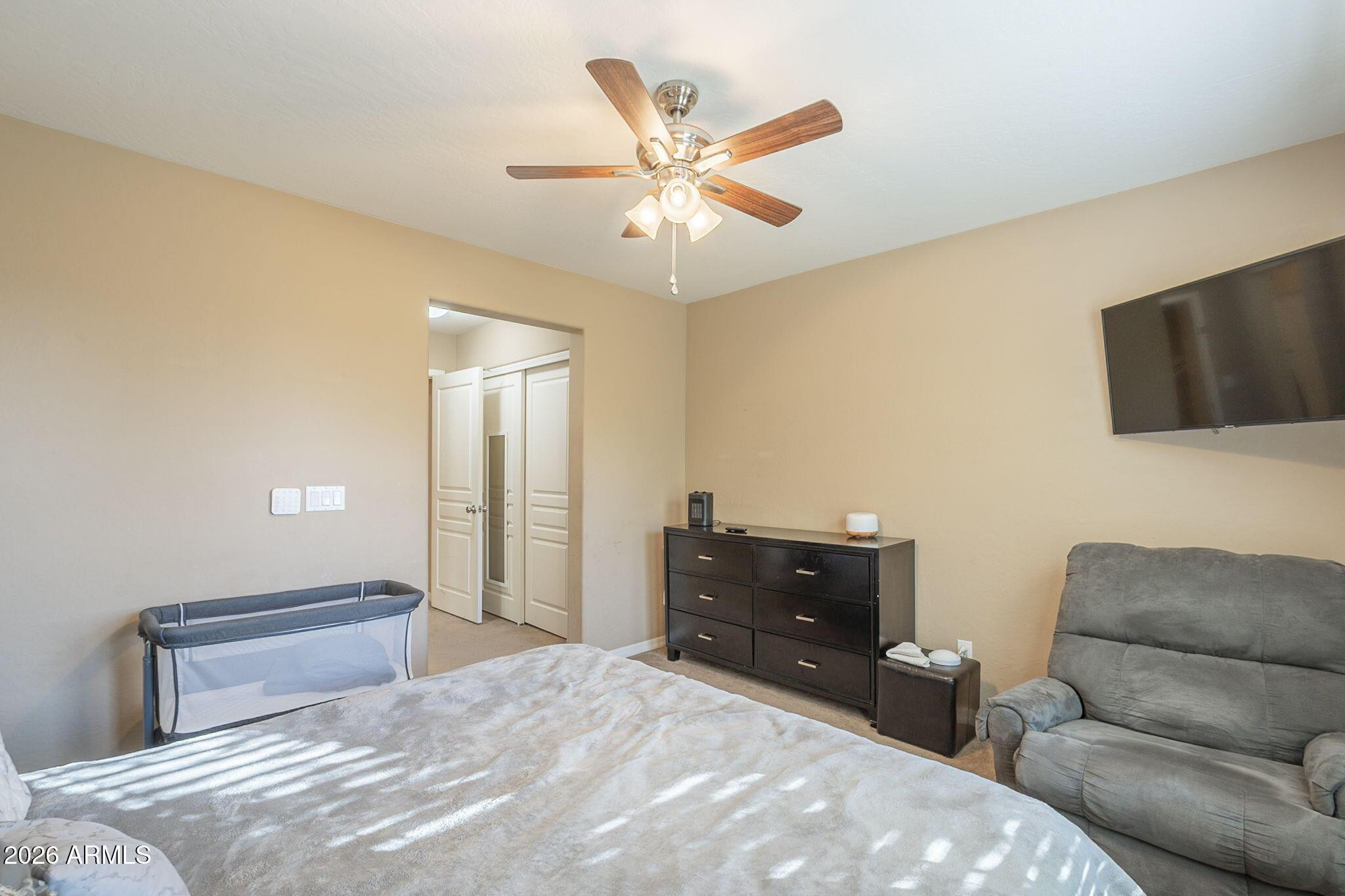 451 South Hawes Road, Unit 45 Mesa, AZ 85208 - Photo 16 of 36 a bedroom with a bed and flat screen tv