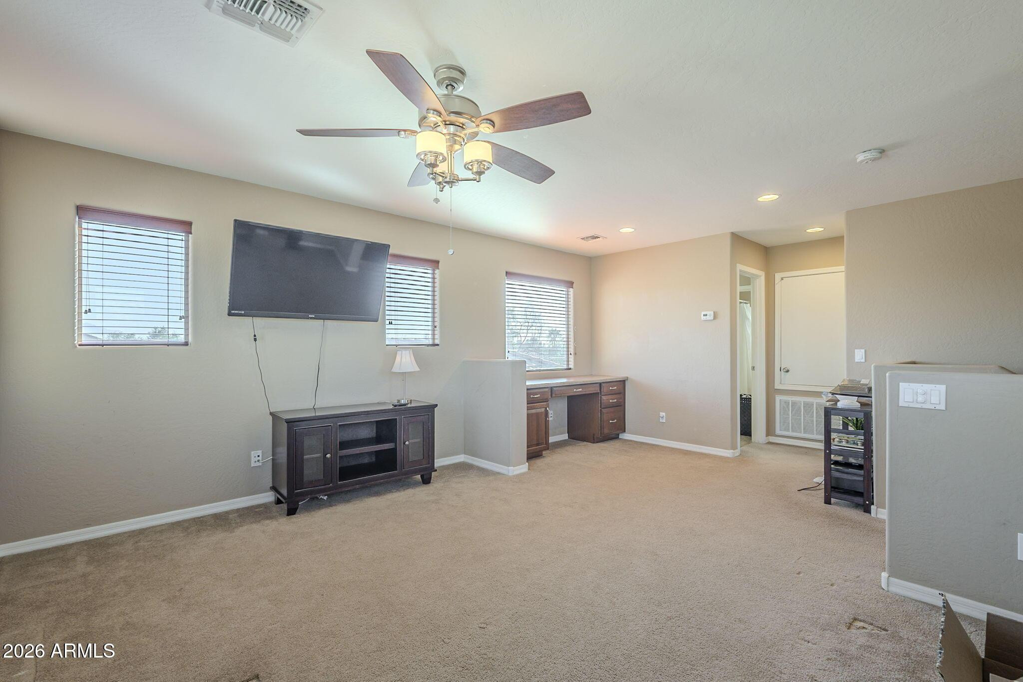 451 South Hawes Road, Unit 45 Mesa, AZ 85208 - Photo 25 of 36 a view of a livingroom with furniture and a flat screen tv