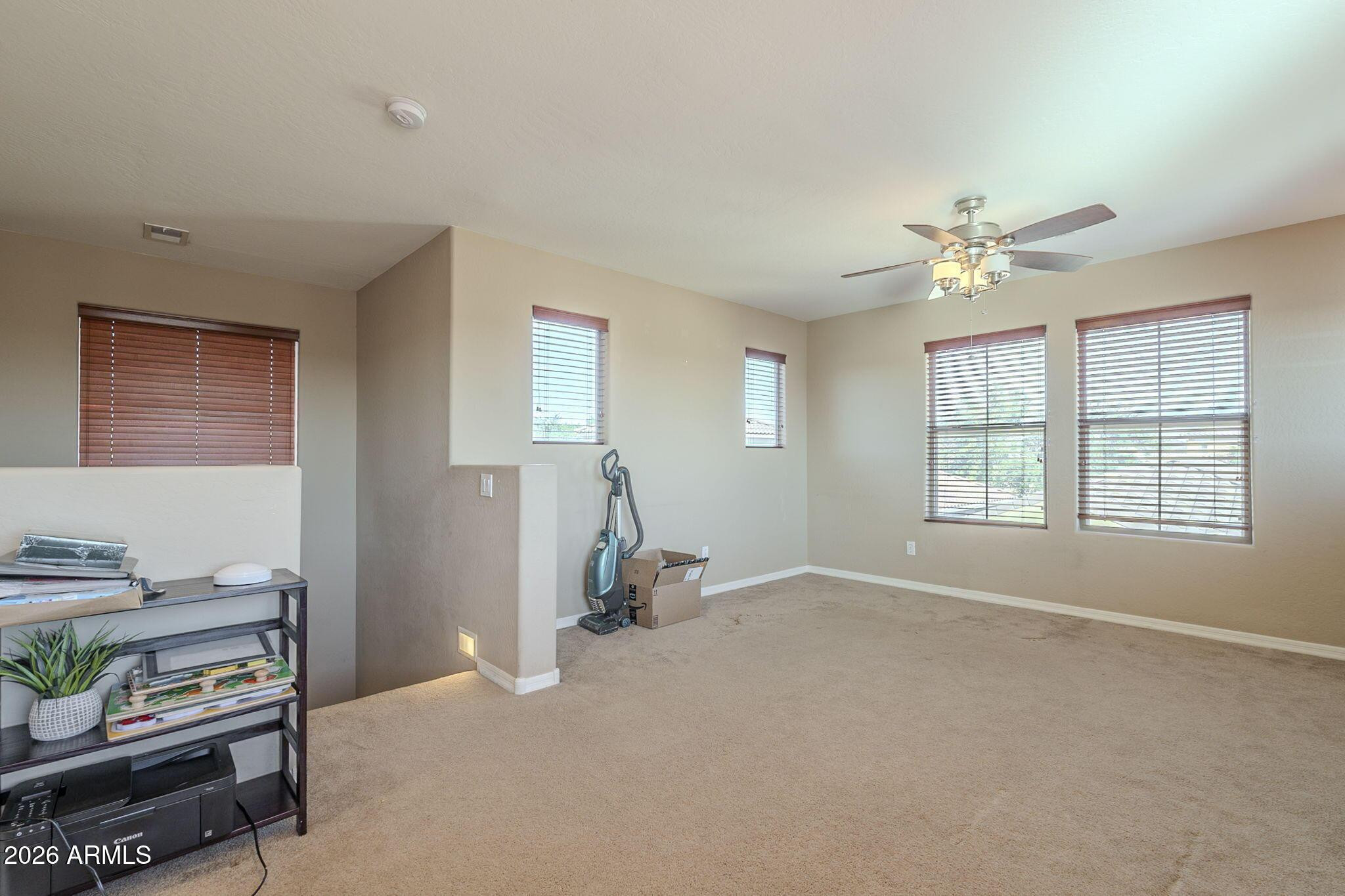 451 South Hawes Road, Unit 45 Mesa, AZ 85208 - Photo 27 of 36 an empty room with windows and ceiling fan