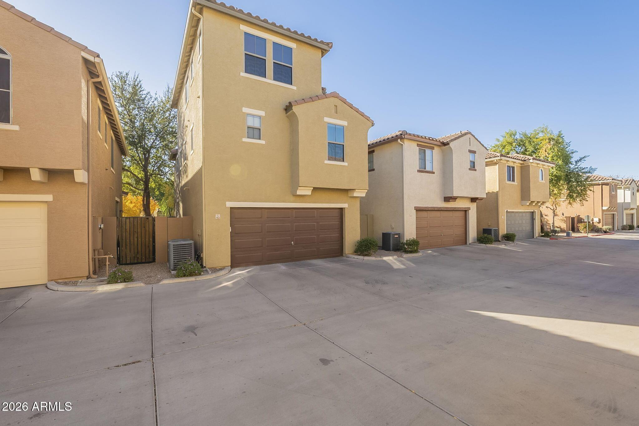 451 South Hawes Road, Unit 45 Mesa, AZ 85208 - Photo 34 of 36 a front view of a house with a yard and garage