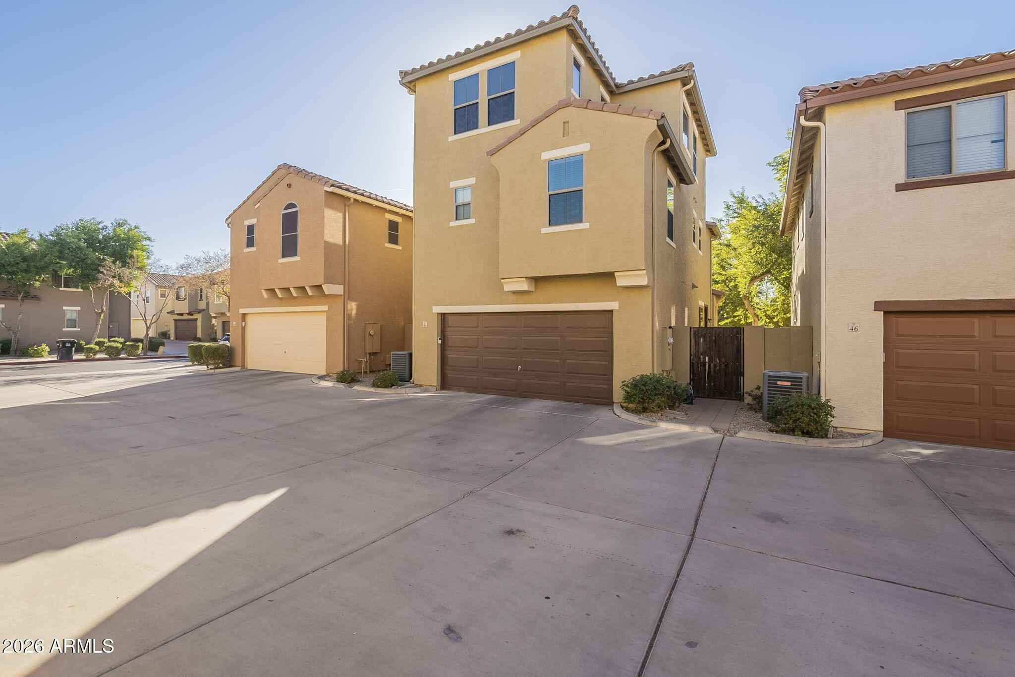 451 South Hawes Road, Unit 45 Mesa, AZ 85208 - Photo 35 of 36 a front view of a house with a yard and garage