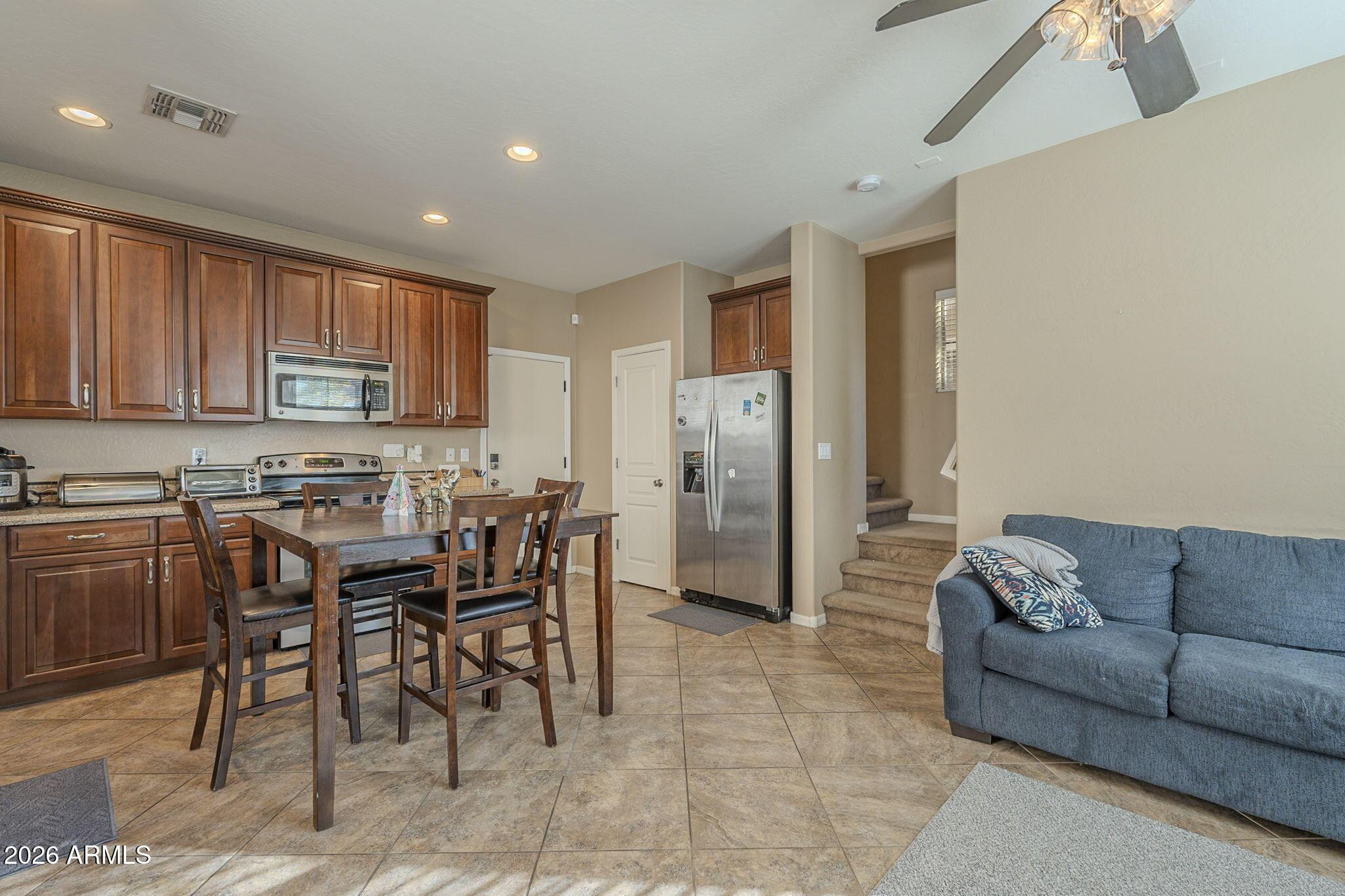 451 South Hawes Road, Unit 45 Mesa, AZ 85208 - Photo 8 of 36 a living room with stainless steel appliances kitchen island granite countertop furniture and a refrigerator