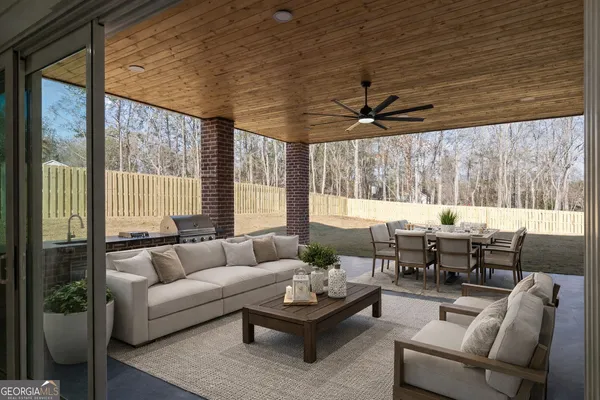 a large white kitchen with cabinets and a large window