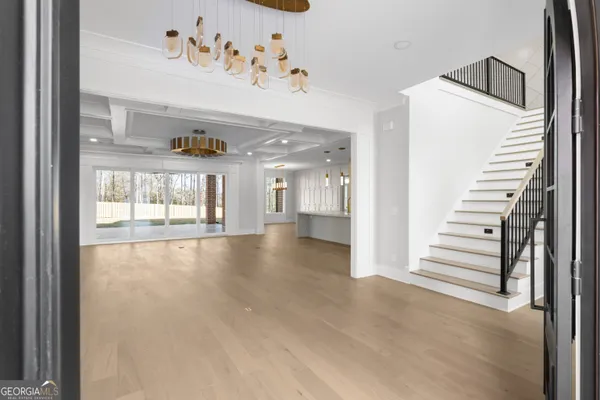 a large kitchen with kitchen island a sink stainless steel appliances and cabinets