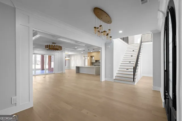 a large kitchen with a large counter top sink stainless steel appliances and cabinets