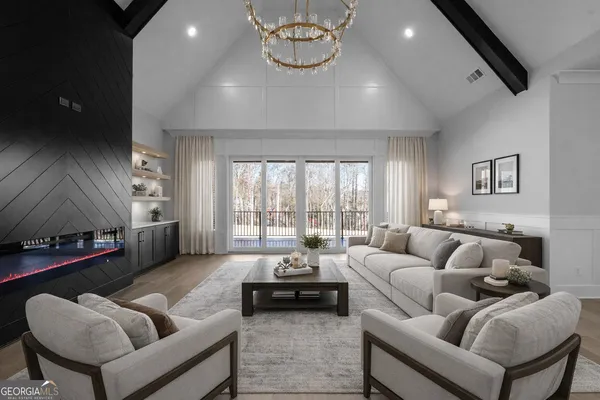 a living room with furniture a rug and a chandelier