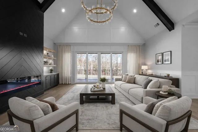 a living room with furniture a rug and a chandelier