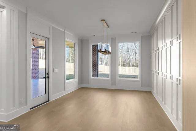 a view of a livingroom with a ceiling fan and window