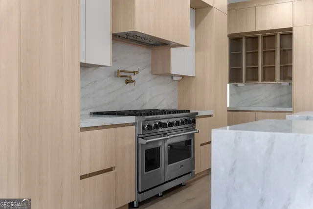a kitchen with granite countertop a sink and a stove top oven