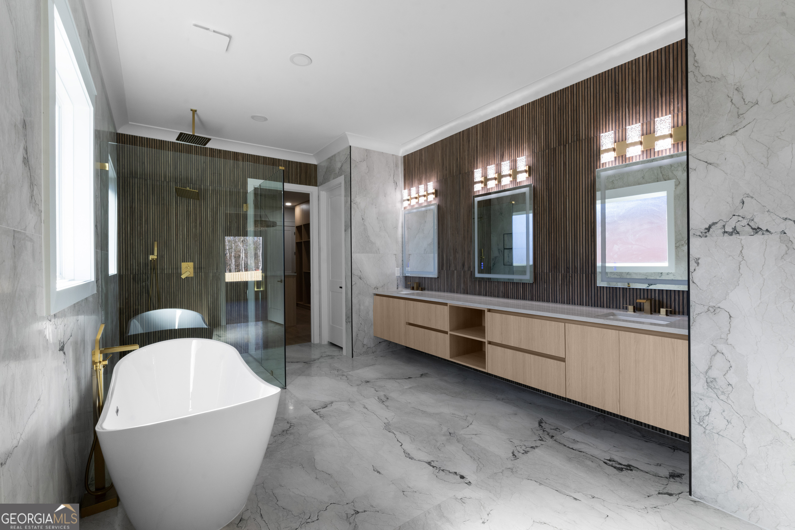 407 Thunder Road Buford, GA 30518 - Photo 64 of 133 a large bathroom with double vanity sinks a toilet a glass door and a shower