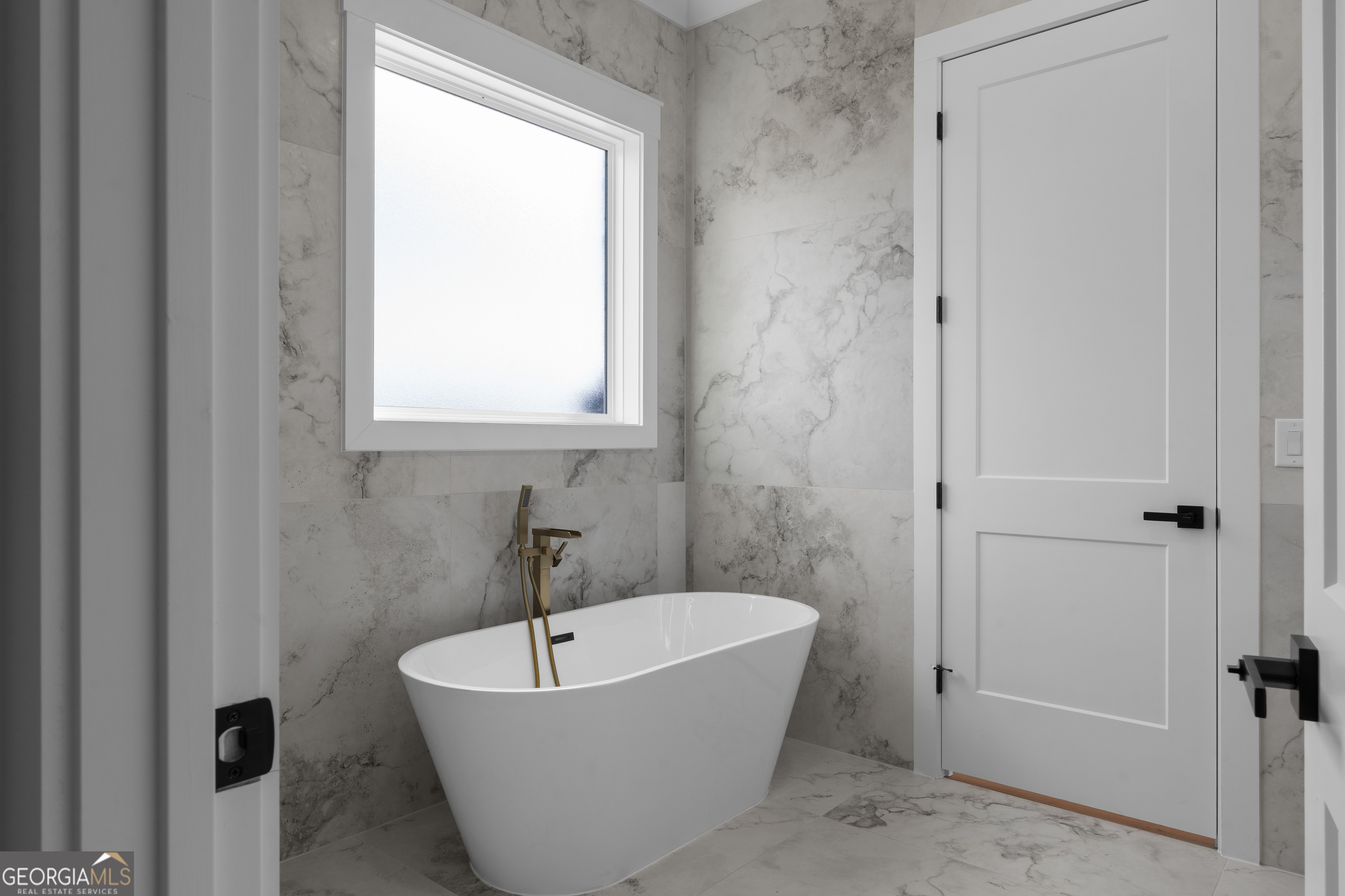 407 Thunder Road Buford, GA 30518 - Photo 88 of 133 a white bath tub sitting in a bathroom next to a window