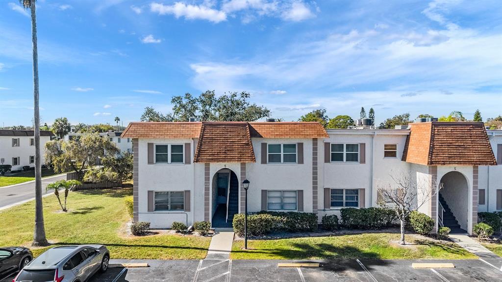 a view of house with yard and furniture