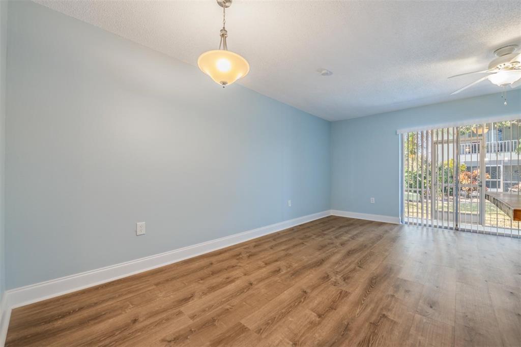 233 South McMullen Booth Road, Unit 43 Clearwater, FL 33759 - Photo 3 of 23 a view of an empty room with wooden floor and a window