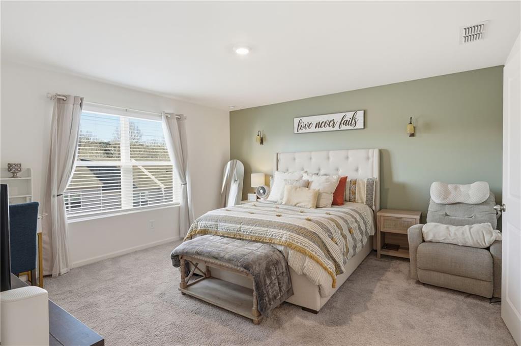 60 Thetford Way Winder, GA 30680 - Photo 14 of 34 a spacious bedroom with a bed and a couch