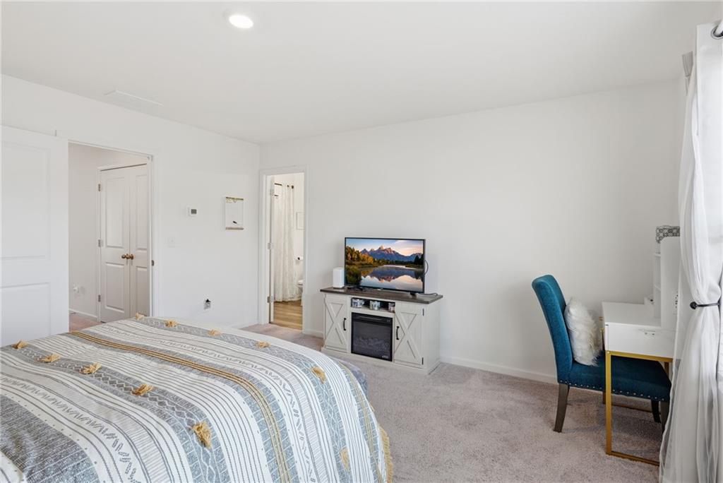 60 Thetford Way Winder, GA 30680 - Photo 16 of 34 a bedroom with a bed and a chair in it