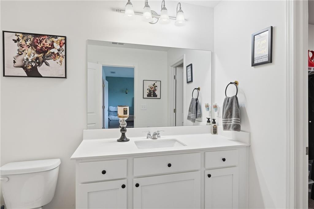 60 Thetford Way Winder, GA 30680 - Photo 18 of 34 a bathroom with a toilet sink and mirror