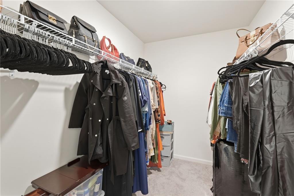 60 Thetford Way Winder, GA 30680 - Photo 19 of 34 a view of walk in closet with clothes and shoes