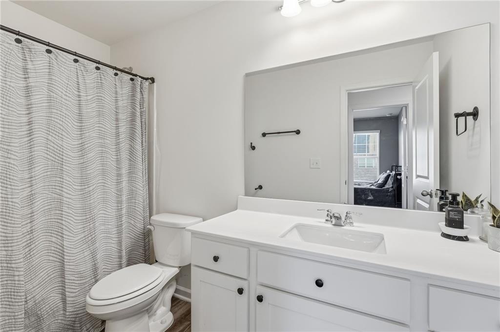 60 Thetford Way Winder, GA 30680 - Photo 21 of 34 a bathroom with a sink a toilet and shower curtain