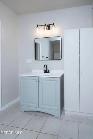 a bathroom with a sink and a mirror