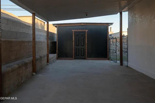 a view of a hallway with wooden shelves