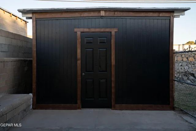 a view of an empty room with wooden floor and windows