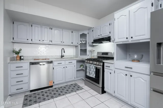 a kitchen with cabinets appliances and a sink