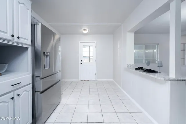 a view of a kitchen with a refrigerator cabinets and a wooden floor