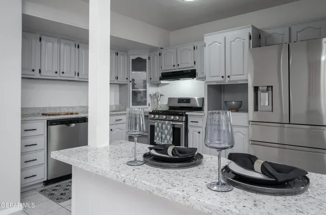 a kitchen with sink a stove and refrigerator