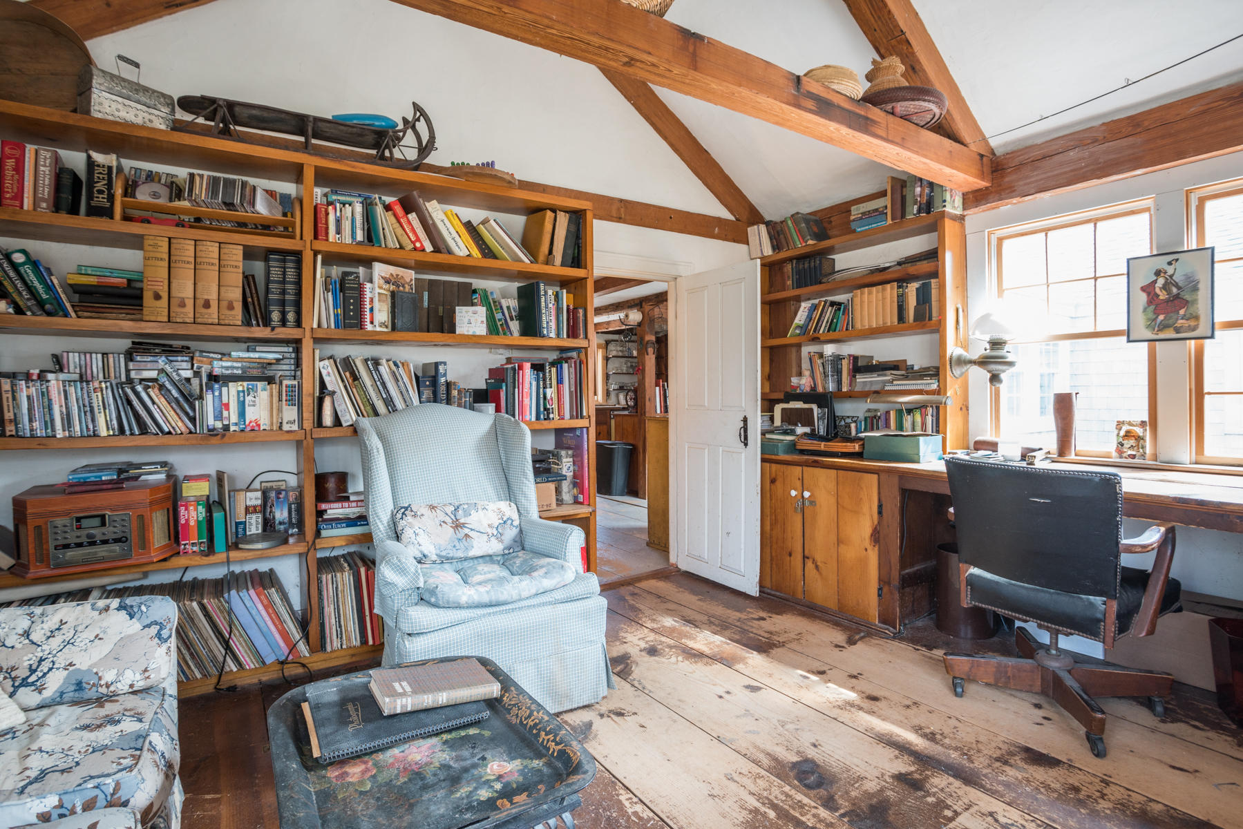 46 Namskaket Road Orleans, MA 02653 - Photo 21 of 35 a living room with fireplace furniture and a book shelf