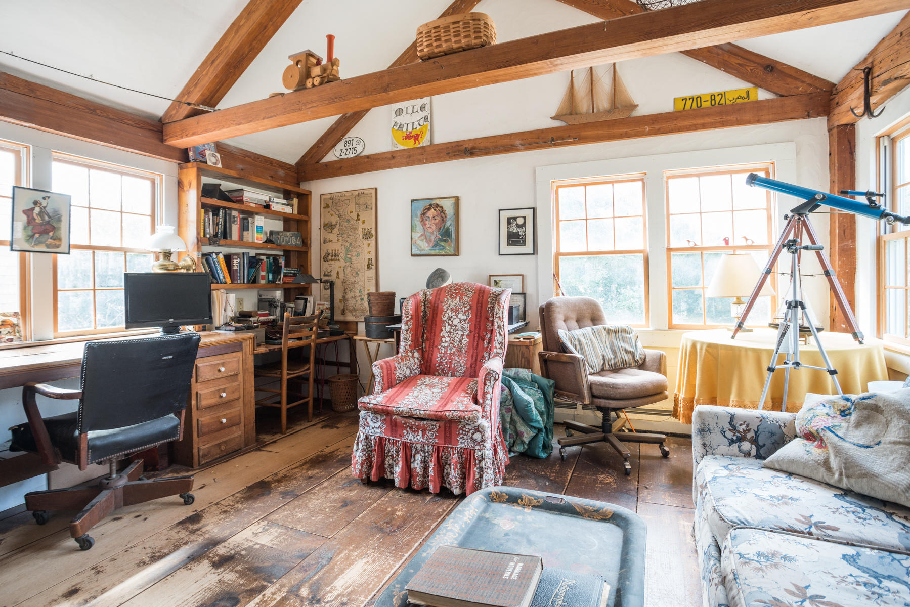 46 Namskaket Road Orleans, MA 02653 - Photo 22 of 35 a living room with furniture a flat screen tv and floor to ceiling windows