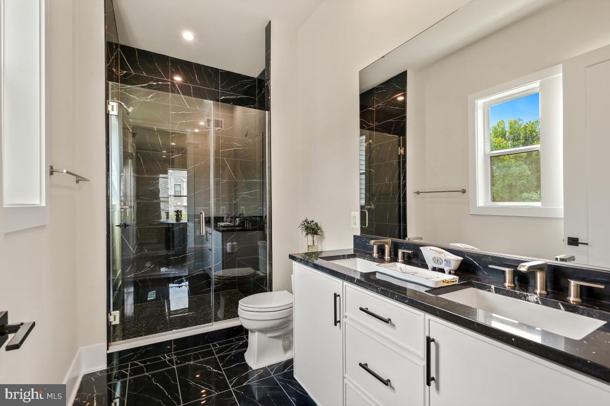 12321 Potomac Hunt Road North Potomac, MD 20878 - Photo 23 of 64 a bathroom with a double vanity sink toilet and shower