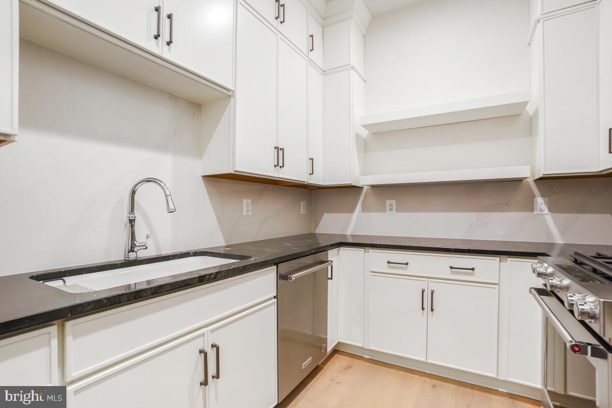 12321 Potomac Hunt Road North Potomac, MD 20878 - Photo 26 of 64 a kitchen with granite countertop white cabinets and a stove