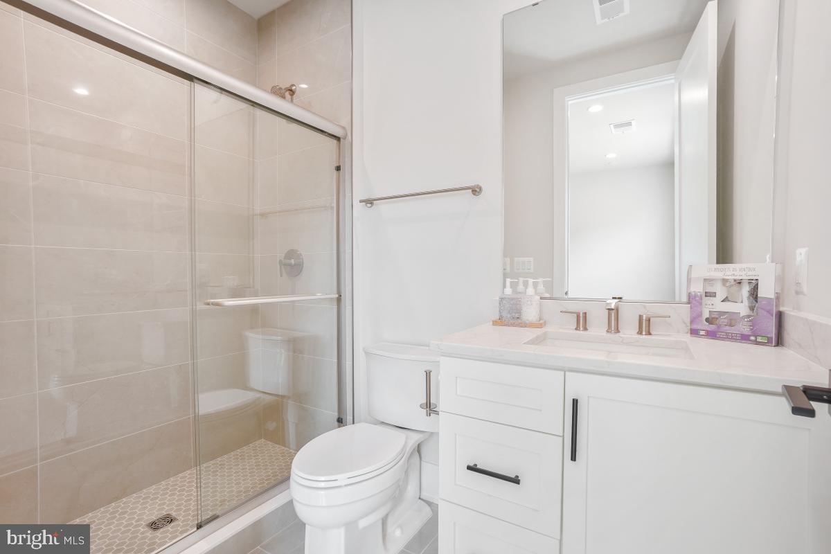 12321 Potomac Hunt Road North Potomac, MD 20878 - Photo 39 of 64 a bathroom with a sink a toilet and shower