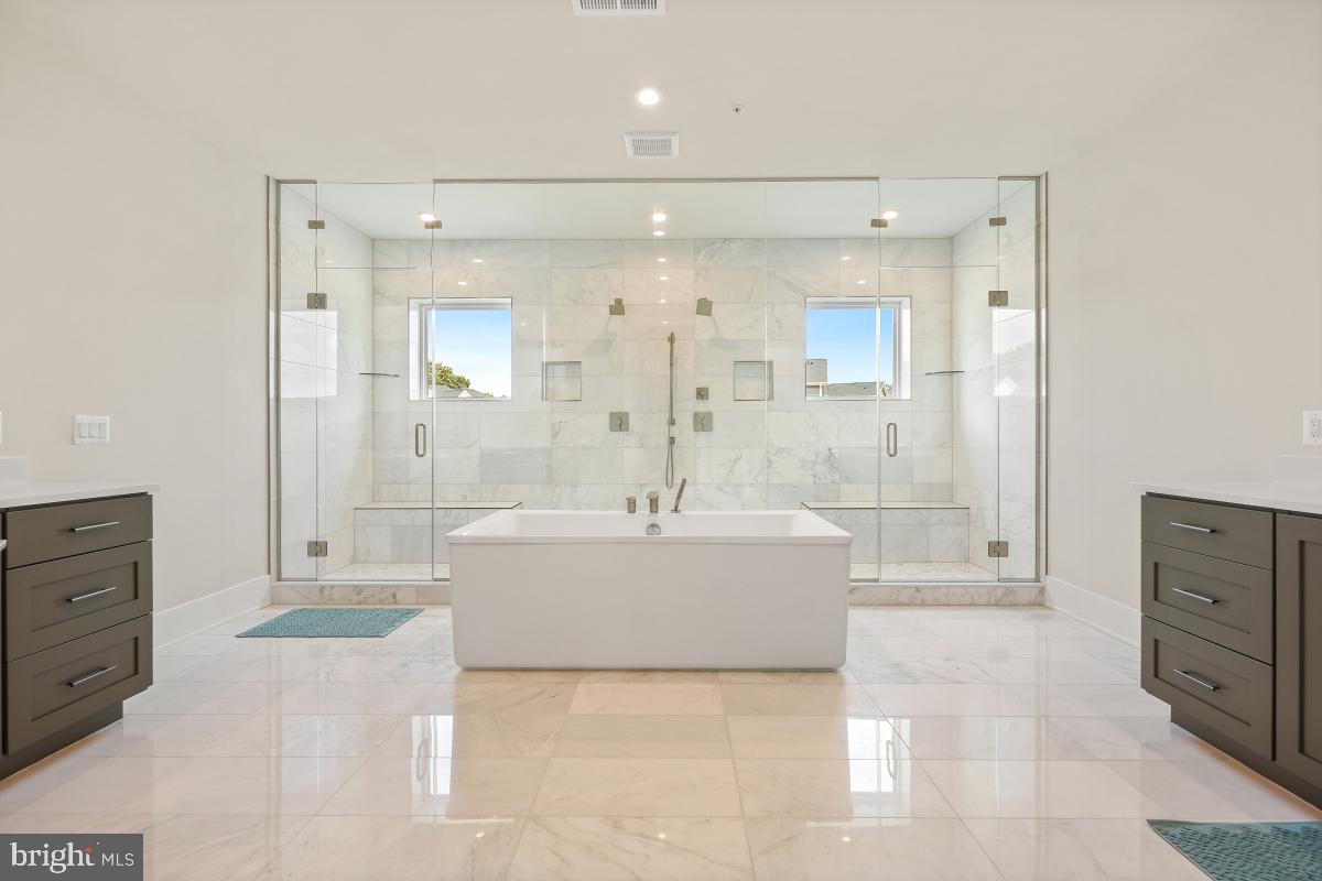 12321 Potomac Hunt Road North Potomac, MD 20878 - Photo 43 of 64 a bathroom with a tub a sink a mirror and a shower