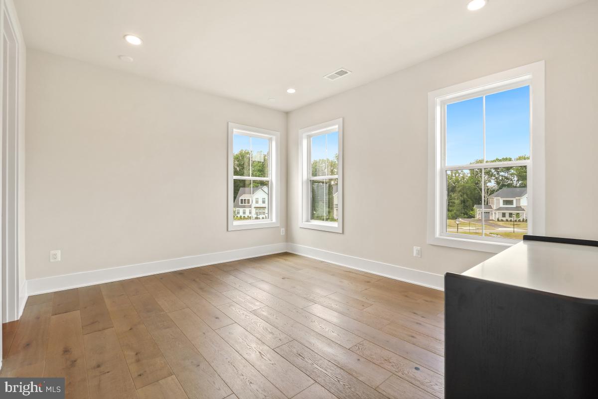 12321 Potomac Hunt Road North Potomac, MD 20878 - Photo 49 of 64 an empty room with wooden floor and windows